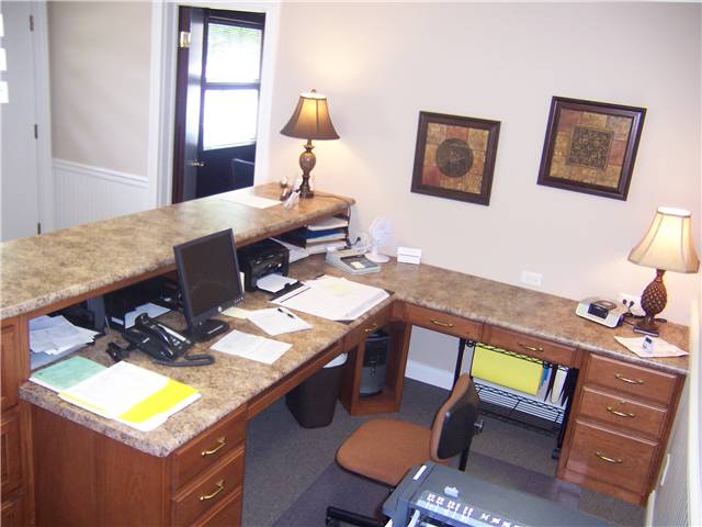 Receptionist desk for an insurance agency - hickory cabinetry with laminate countertops